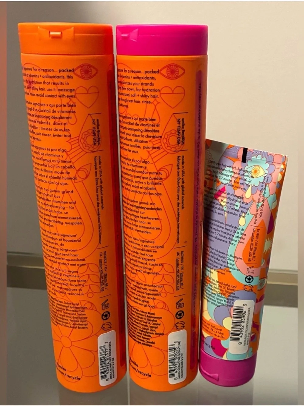 amika Orange Haircare Bottles with Pink Accent